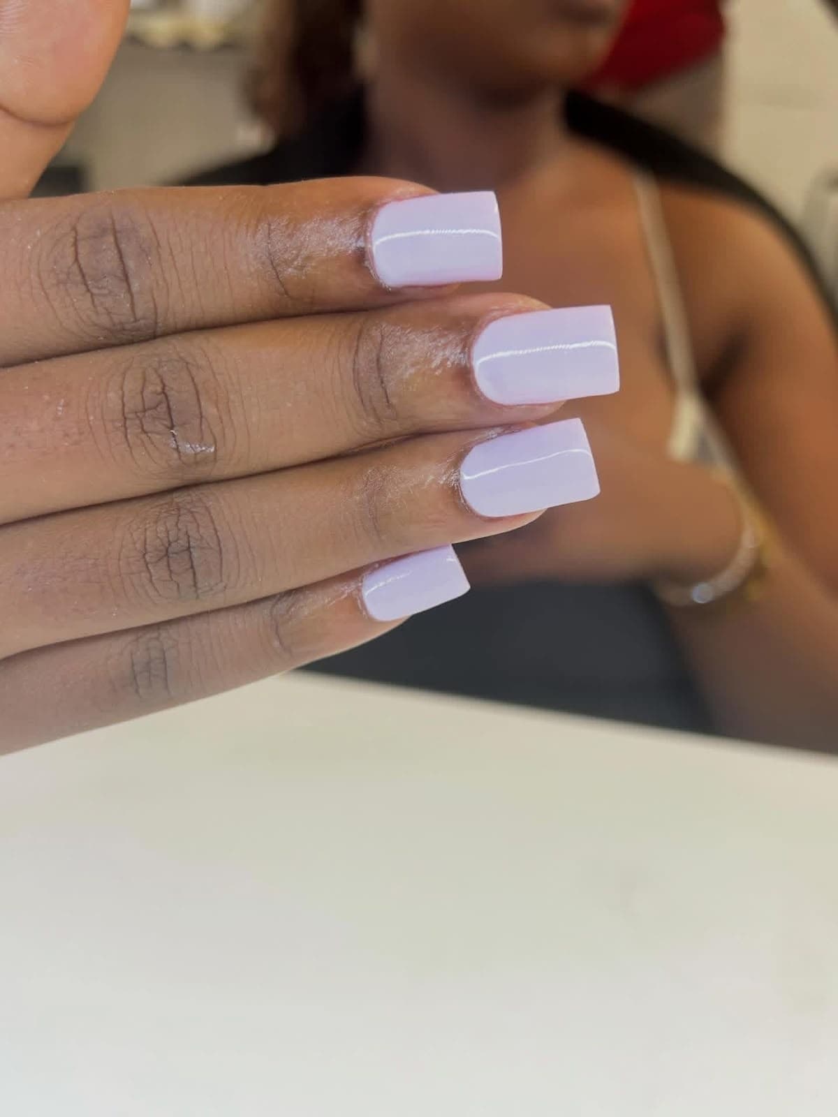 Short square gel nails in a solid lilac colour