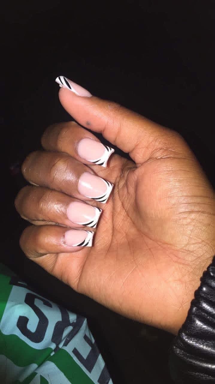 Short square nails with white French tips and black zebra stripes